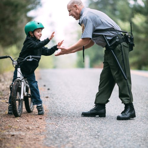 Police Officer Talking to Child on Bike